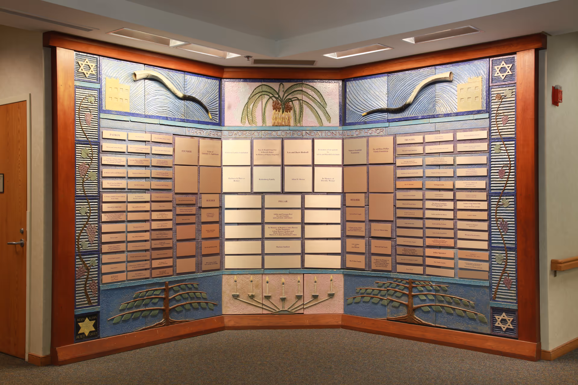 Interior hallway featuring a curved plaque wall and decorative mosaic panels.