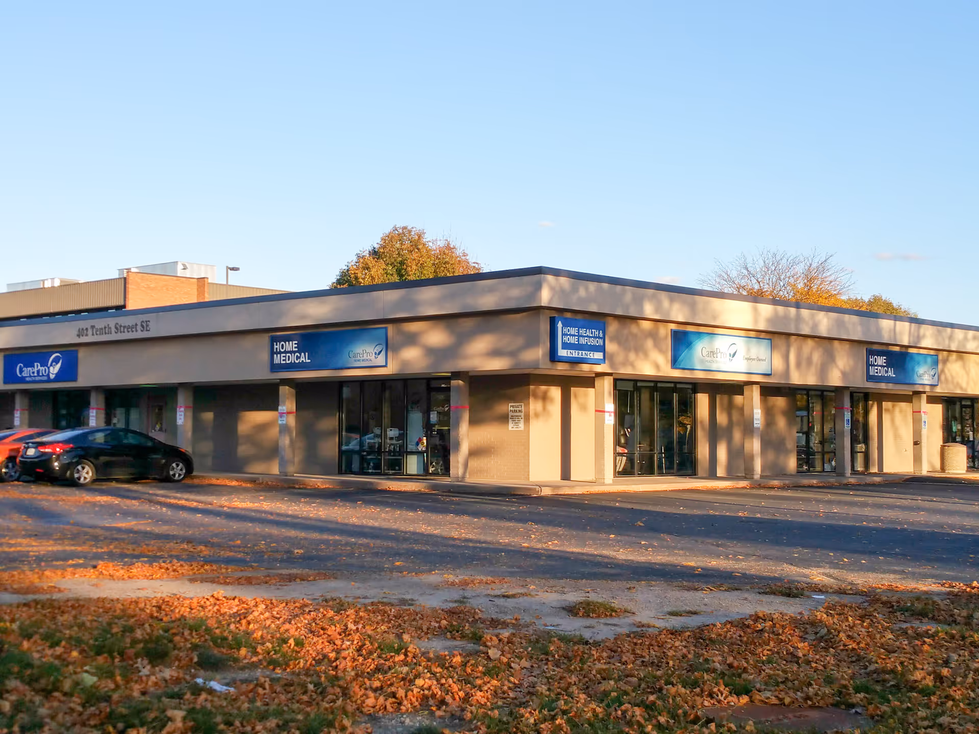 Exterior of a strip mall with CarePro Home Medical storefront signs.