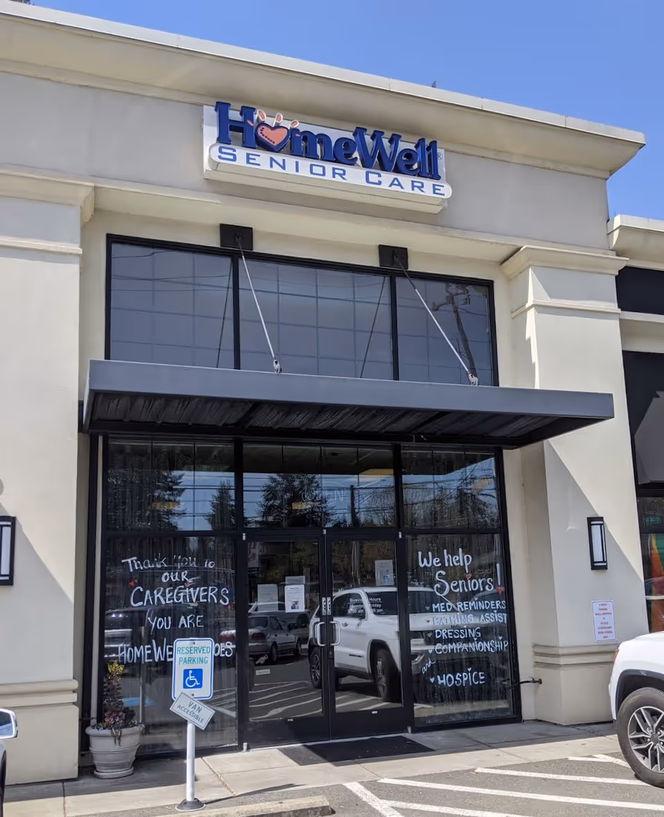 Exterior view of HomeWell Senior Care building with glass entrance doors.