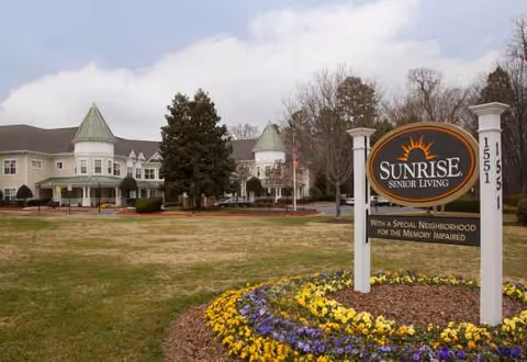 Exterior view of Sunrise at East Cobb with front lawn and entrance sign.