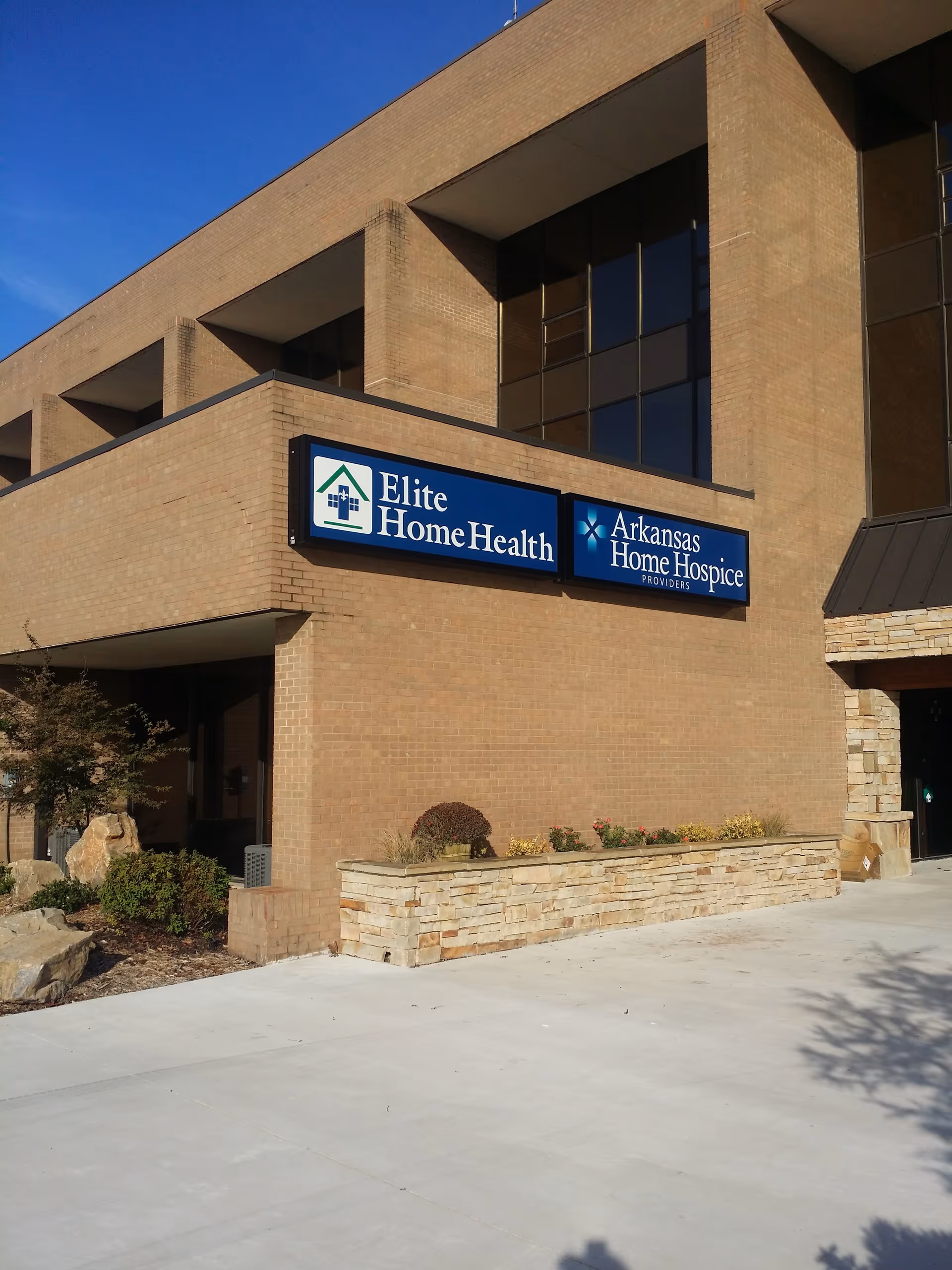 Exterior brick building with Elite Home Health and Arkansas Home Hospice signs