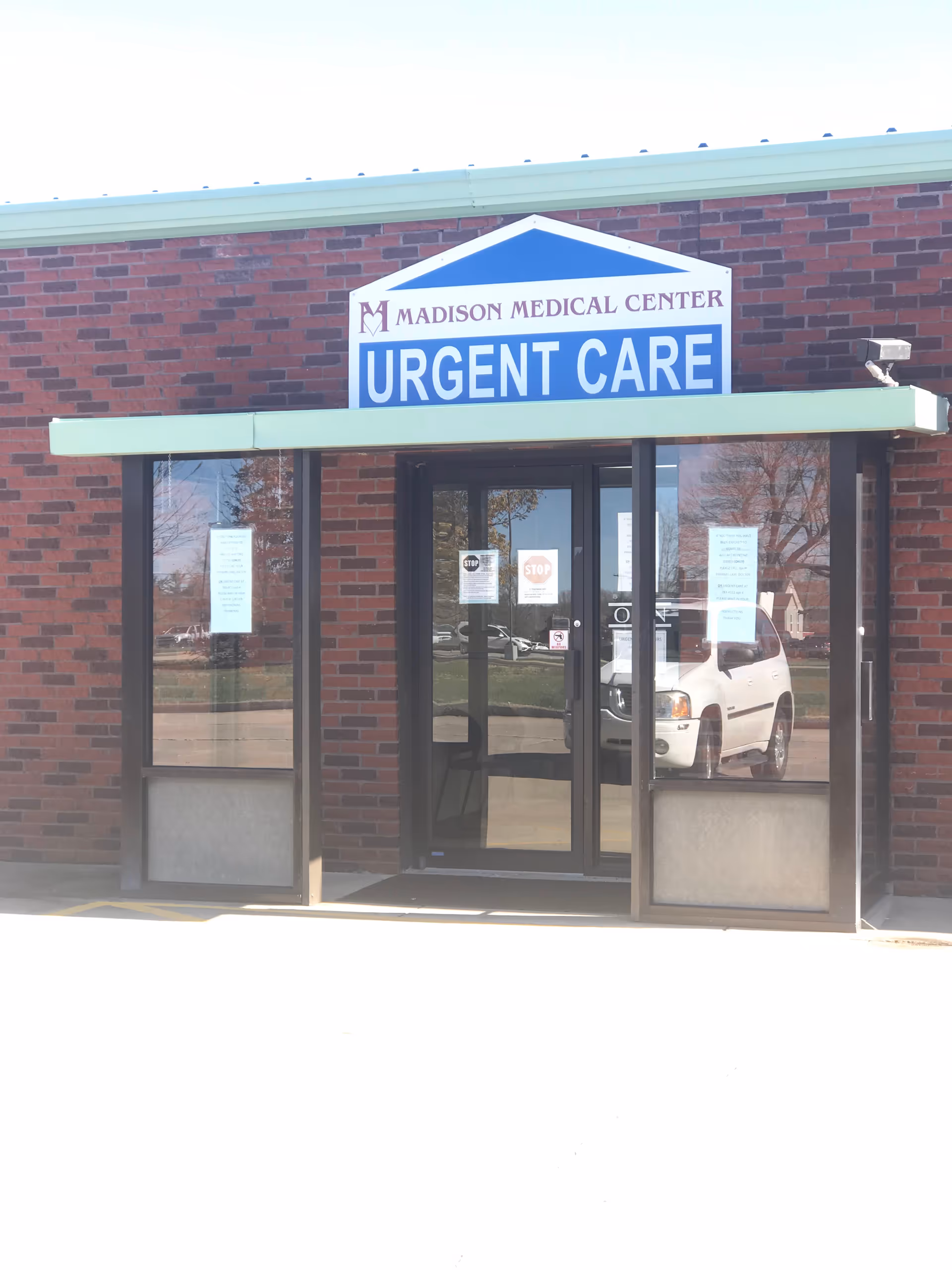 Front of a brick Madison Medical Center with an Urgent Care sign.