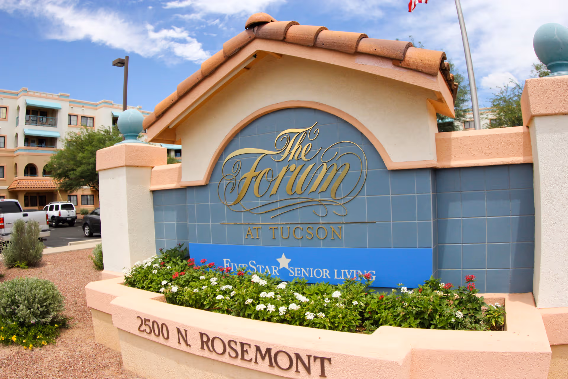 Exterior view of The Forum at Tucson entrance sign with landscaping and a building in background.