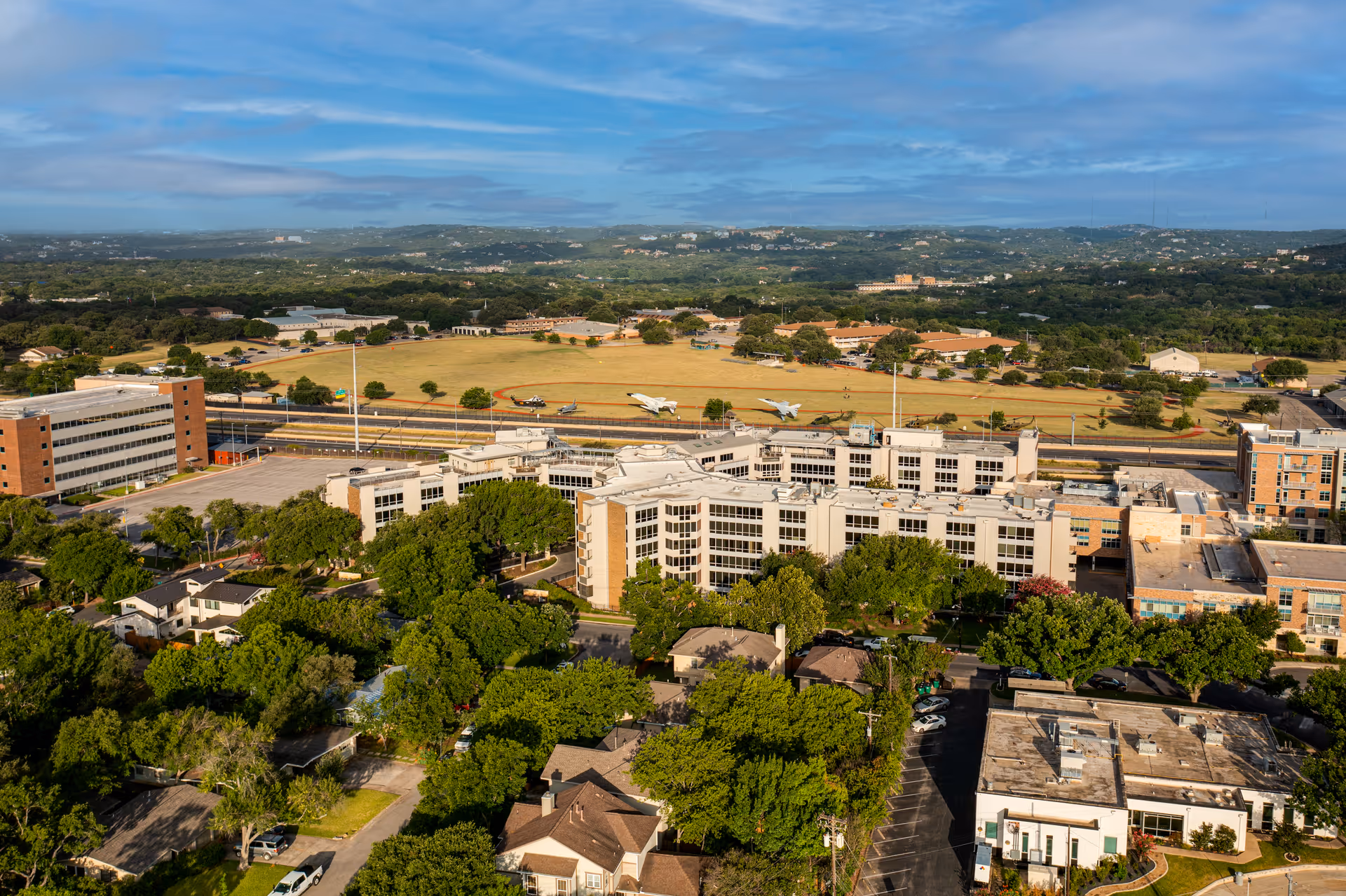 Aerial view of Westminster senior living campus with multiple buildings, trees, and surrounding open landscape.