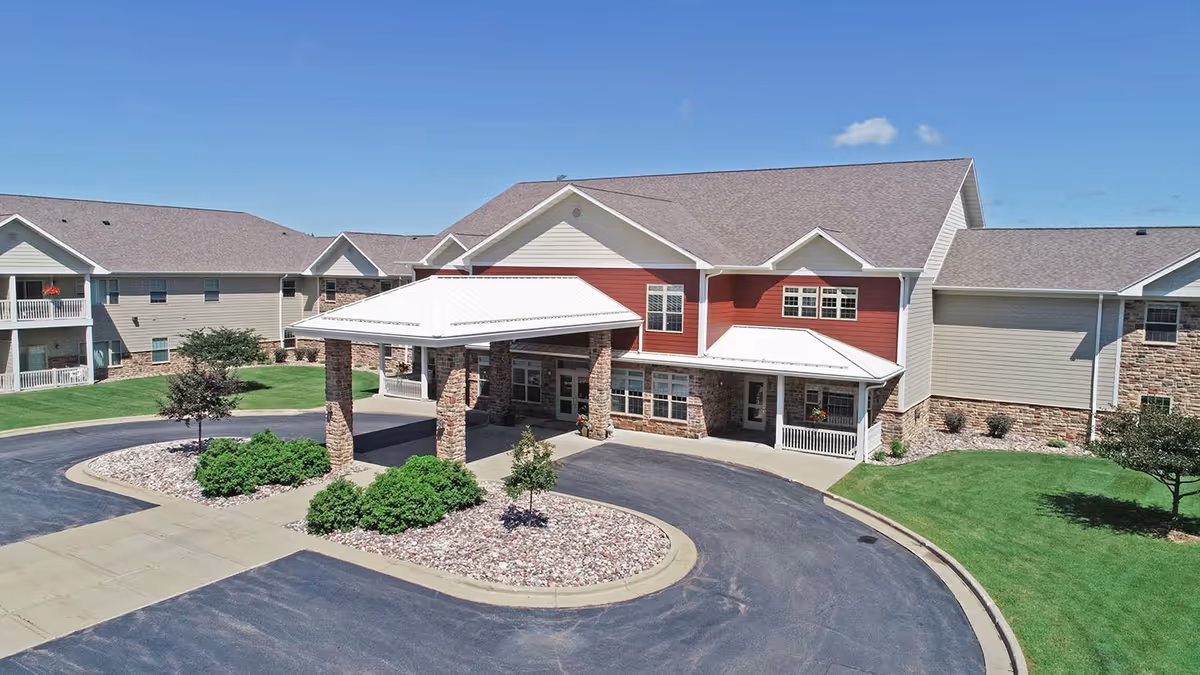 Exterior view of Primrose Retirement Community of Wausau with a covered entrance.