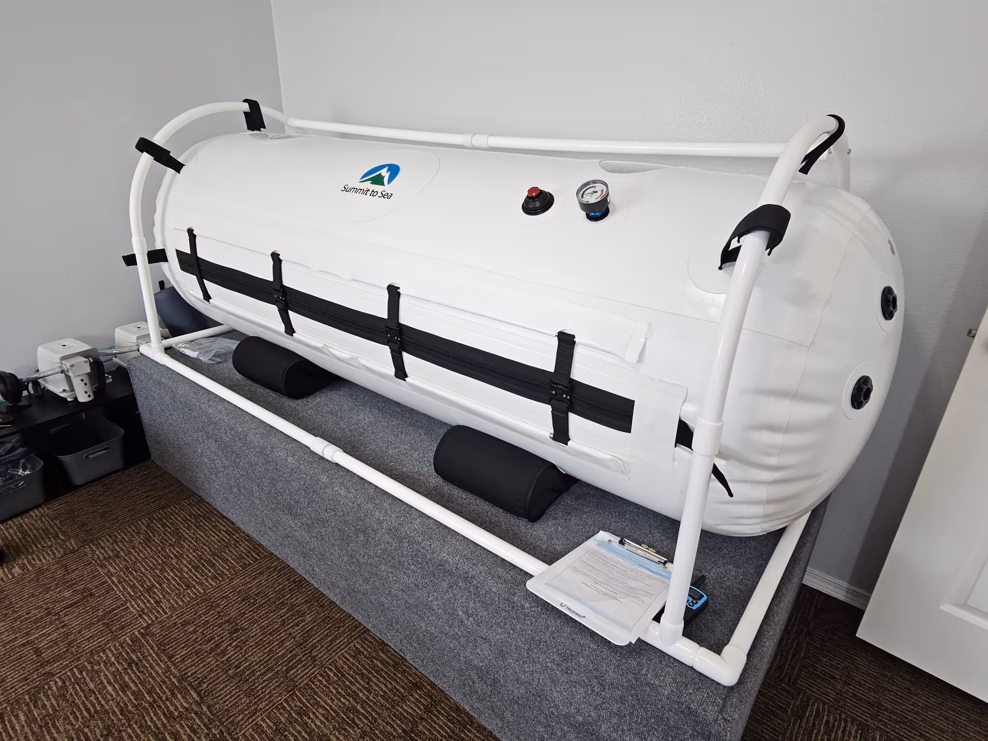 A large white inflatable raft on a gray platform inside a senior living facility room.