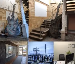 Interior stairwell and hallway featuring brick walls, columns, and artistic sculptures.