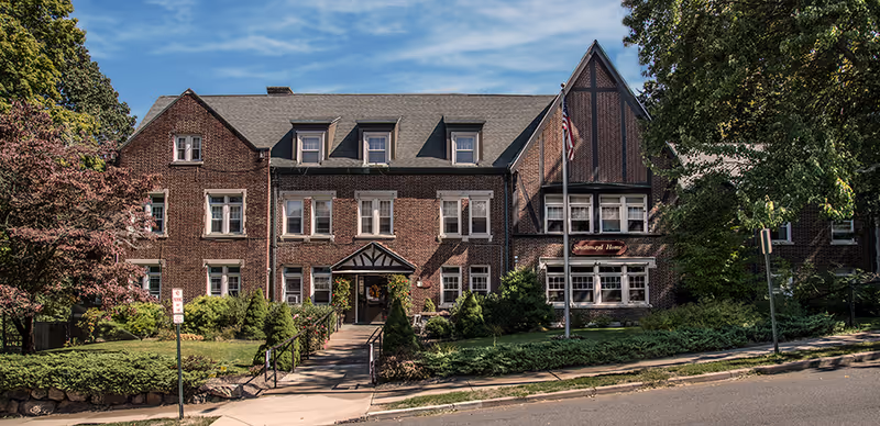Front view of Southmayd Home, brick senior living building with landscaping.