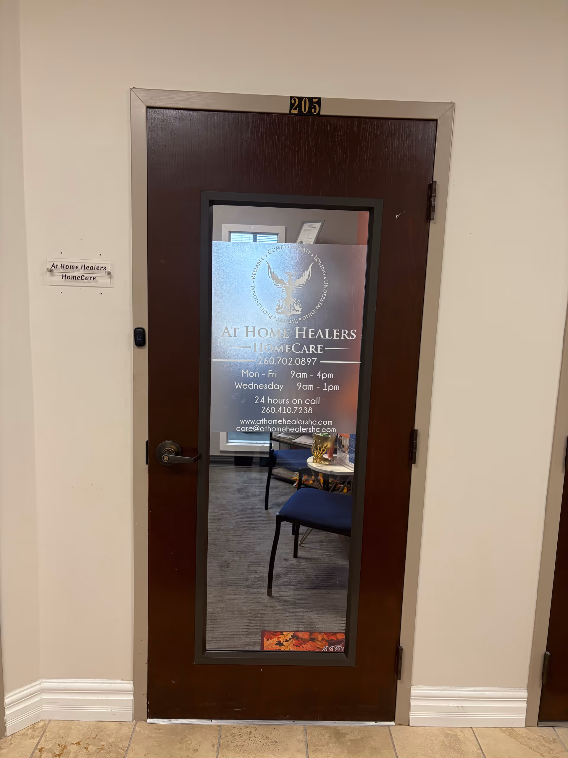 Brown interior door with frosted glass panel displaying At Home Healers HomeCare signage.