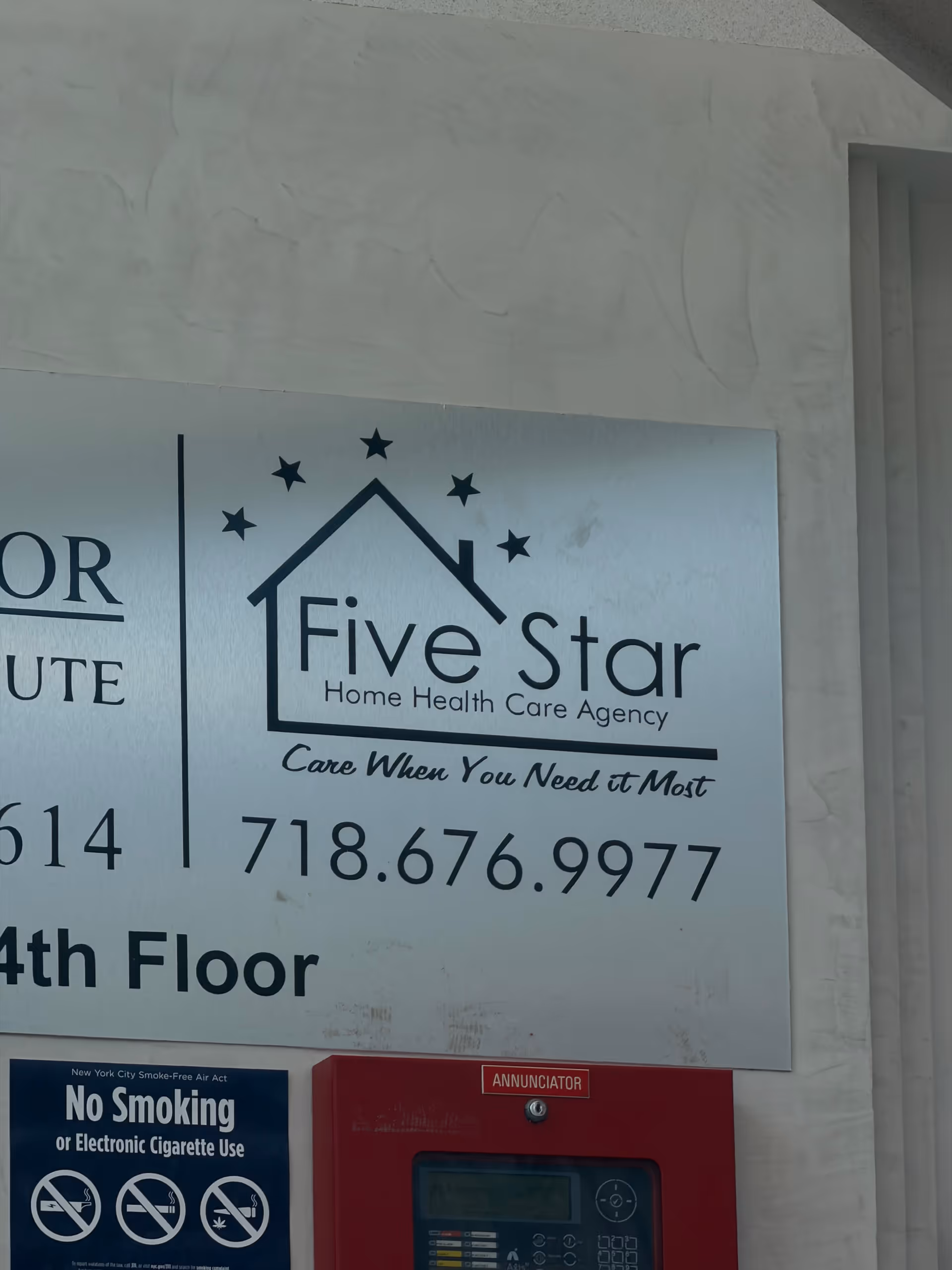 Exterior wall with Five Star Home Health Care Agency sign and no-smoking plaque.