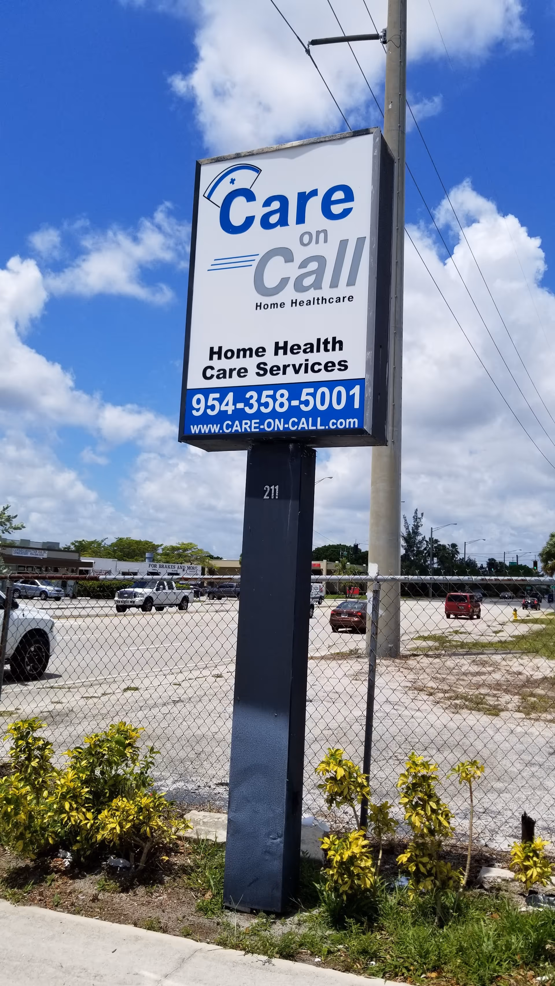 Tall roadside sign for Care on Call Home Healthcare against blue sky.