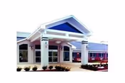 Front exterior view of Holly Heights Nursing Care Center with entrance canopy and landscaping.
