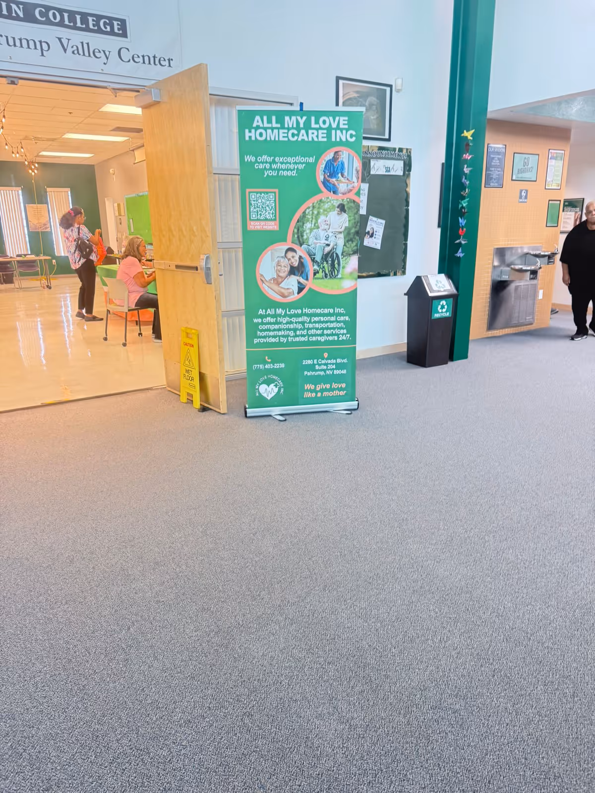 Indoor corridor at All My Love Home Care with a green promotional banner.