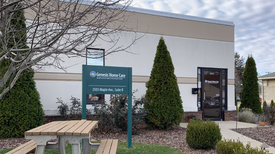 Front exterior of Genesis Home Care facility with sign and landscaping