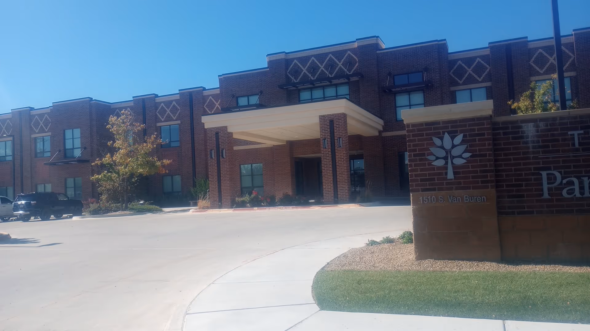 Exterior view of Ware Memorial Care Center with brick facade and covered entrance.