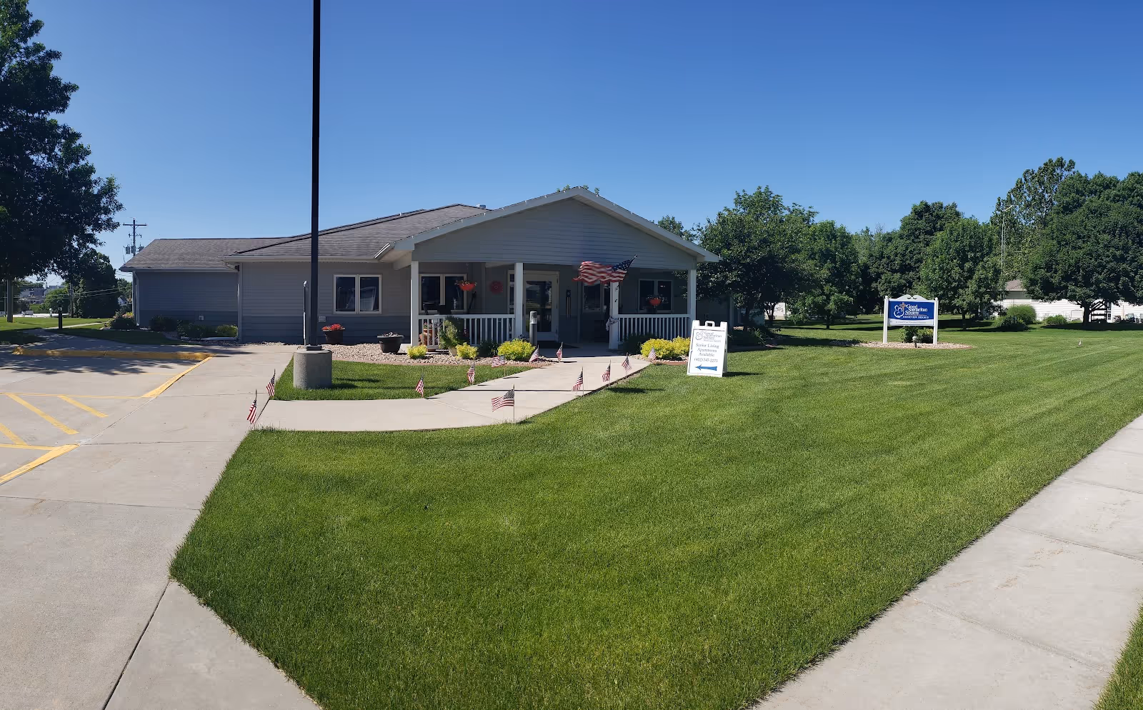 Front view of Good Samaritan Society Ridgeview Heights with a green lawn and walkway.