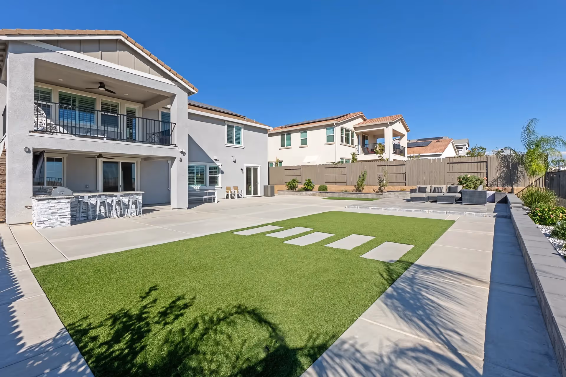 Outdoor shared courtyard of Grand Dignity Homes with seating and green lawn