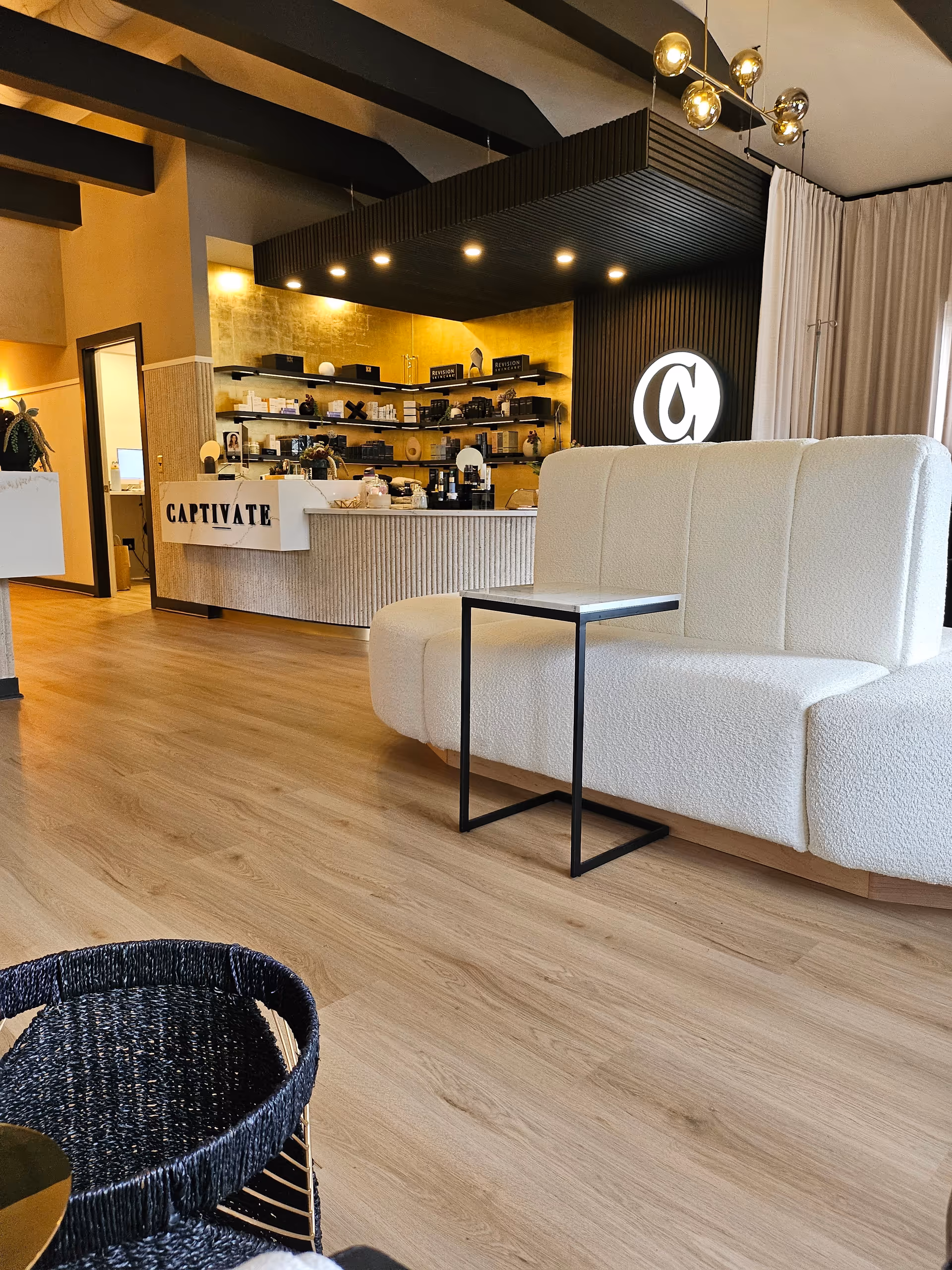 Captivate wellness and beauty bar reception area with seating and product shelves.