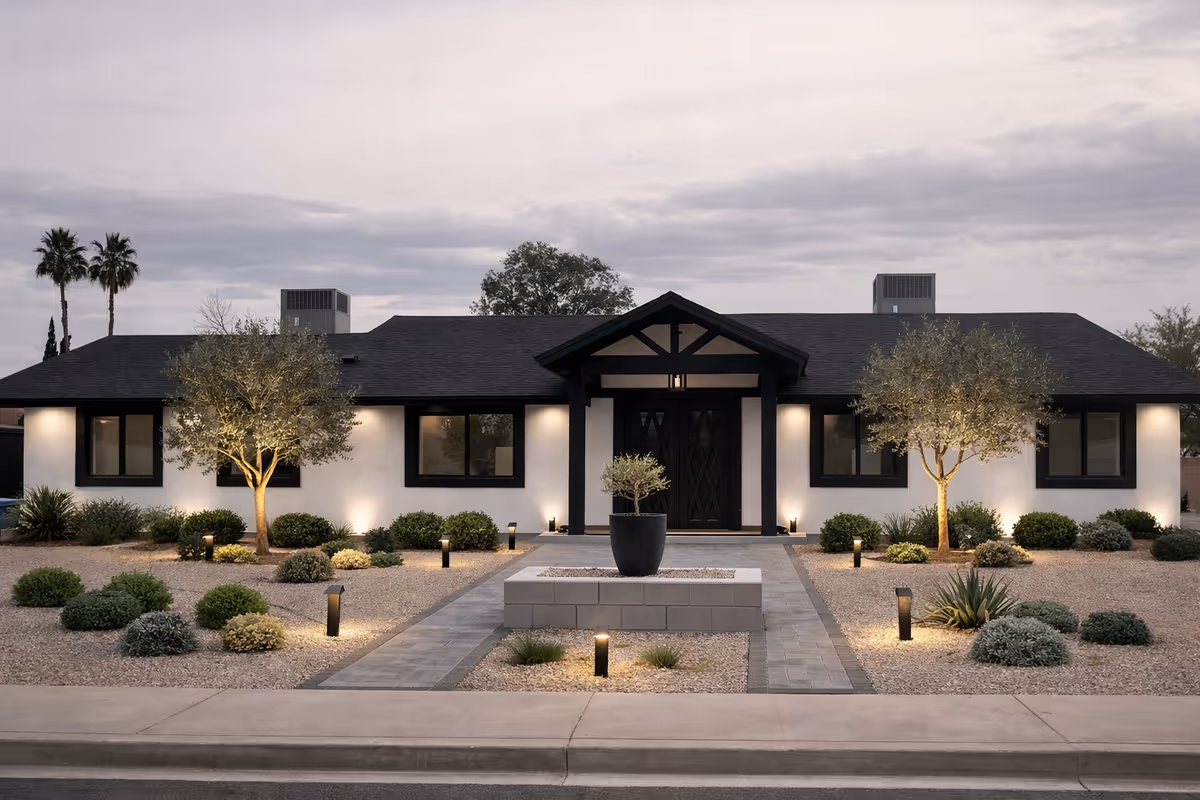 Modern single-story senior care facility exterior with desert landscaping and a central entryway.
