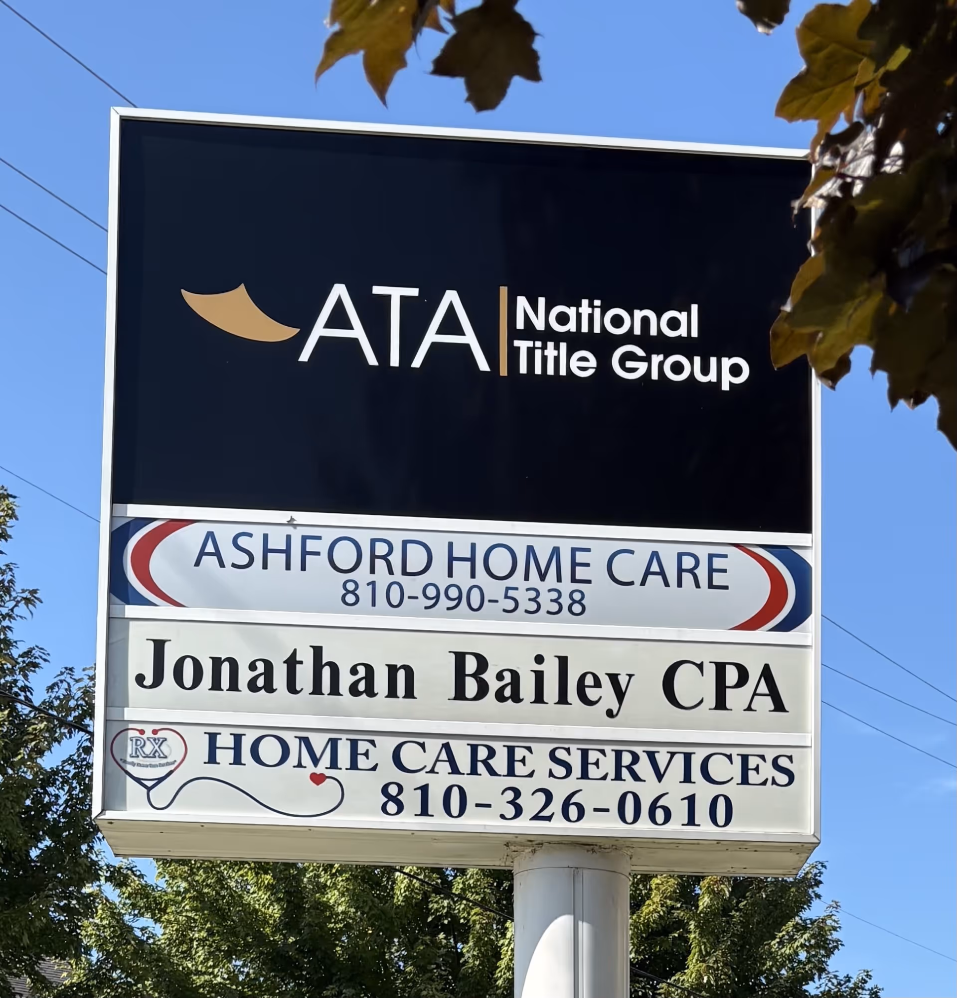 Tall outdoor sign displaying Ashford Home Care and additional business signs.