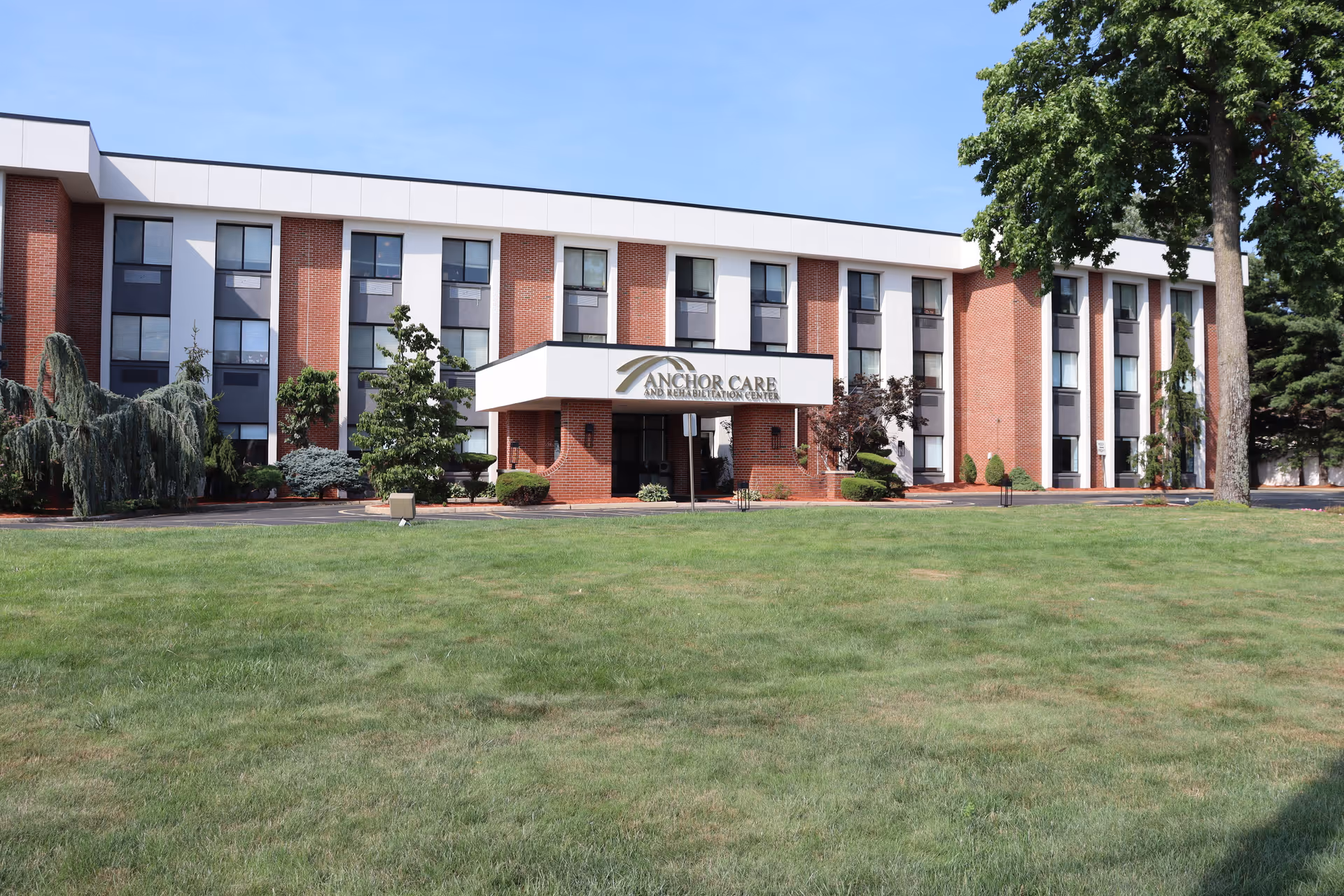 Exterior of Anchor Care and Rehabilitation Center with a green lawn and entrance canopy.