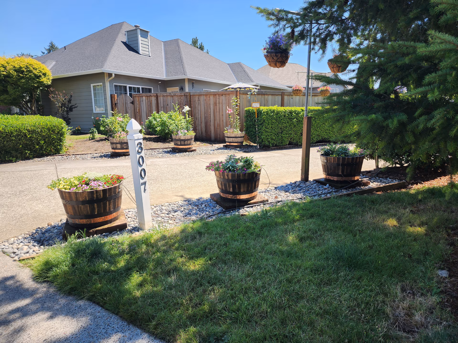 Exterior view of Green Haven Home Care LLC with planters and a fence along a sidewalk.