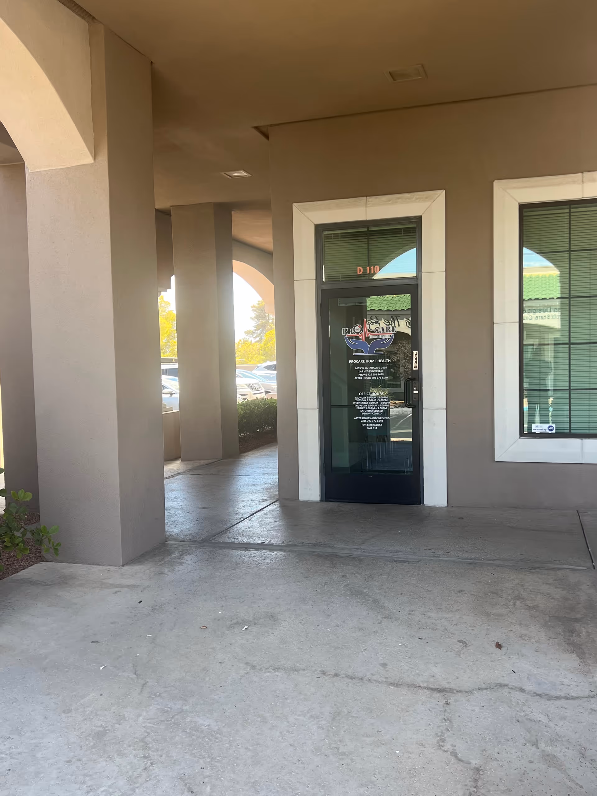 Exterior entrance to Procare Home Health with glass door and columns.