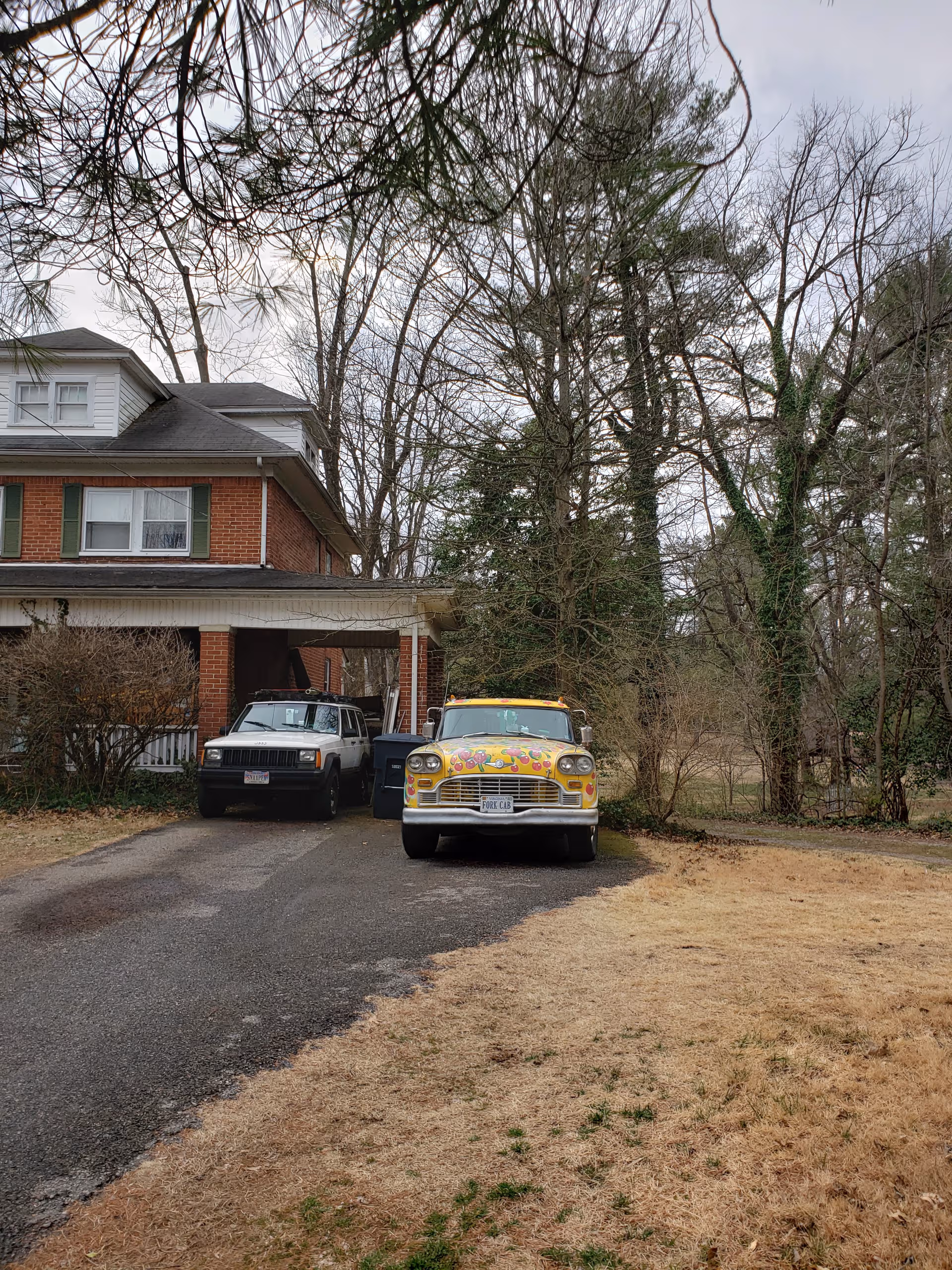Brookdale Roanoke brick facility front with parked cars under a carport.