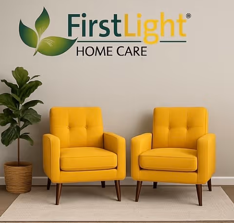 Two yellow armchairs sit in a bright lobby beneath a FirstLight sign.