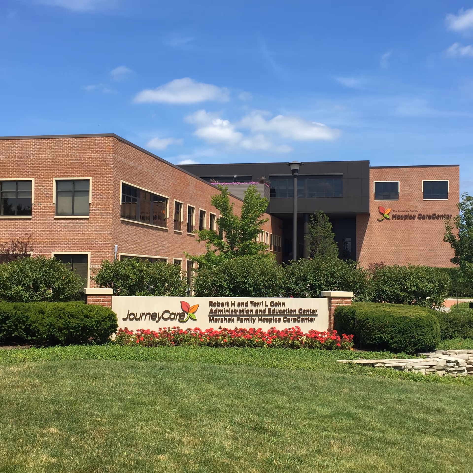 Exterior view of a brick medical facility with JourneyCare signage and landscaped lawn.