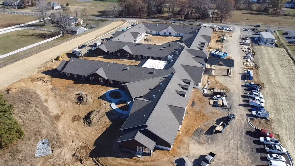 Aerial view of Charter Senior Living of Murray under construction with connected wings and parking.