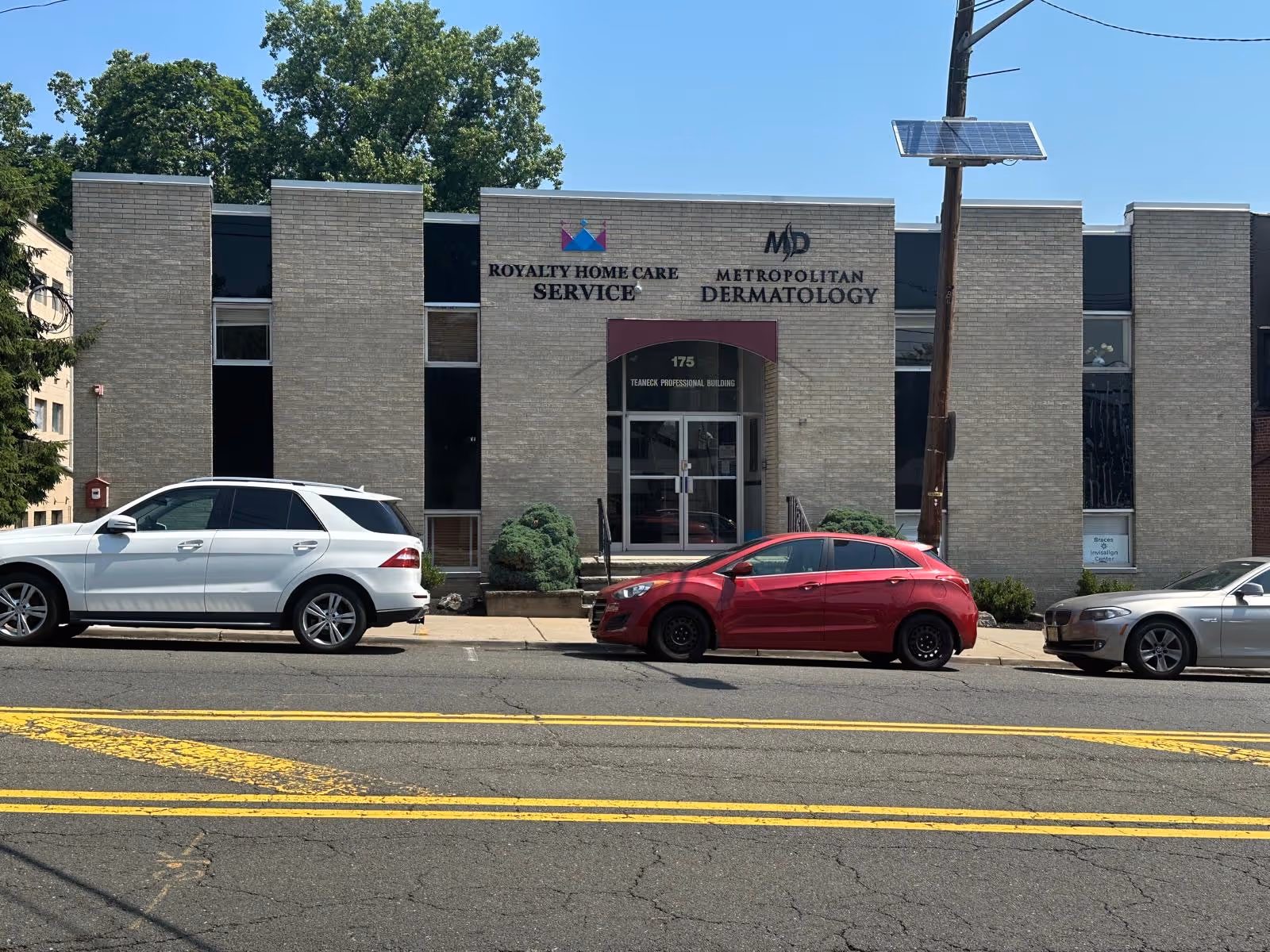 Front view of a brick building with signage for Royalty Home Care Services.