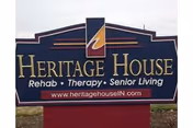 Blue Heritage House sign on a red base advertising rehab, therapy, and senior living.