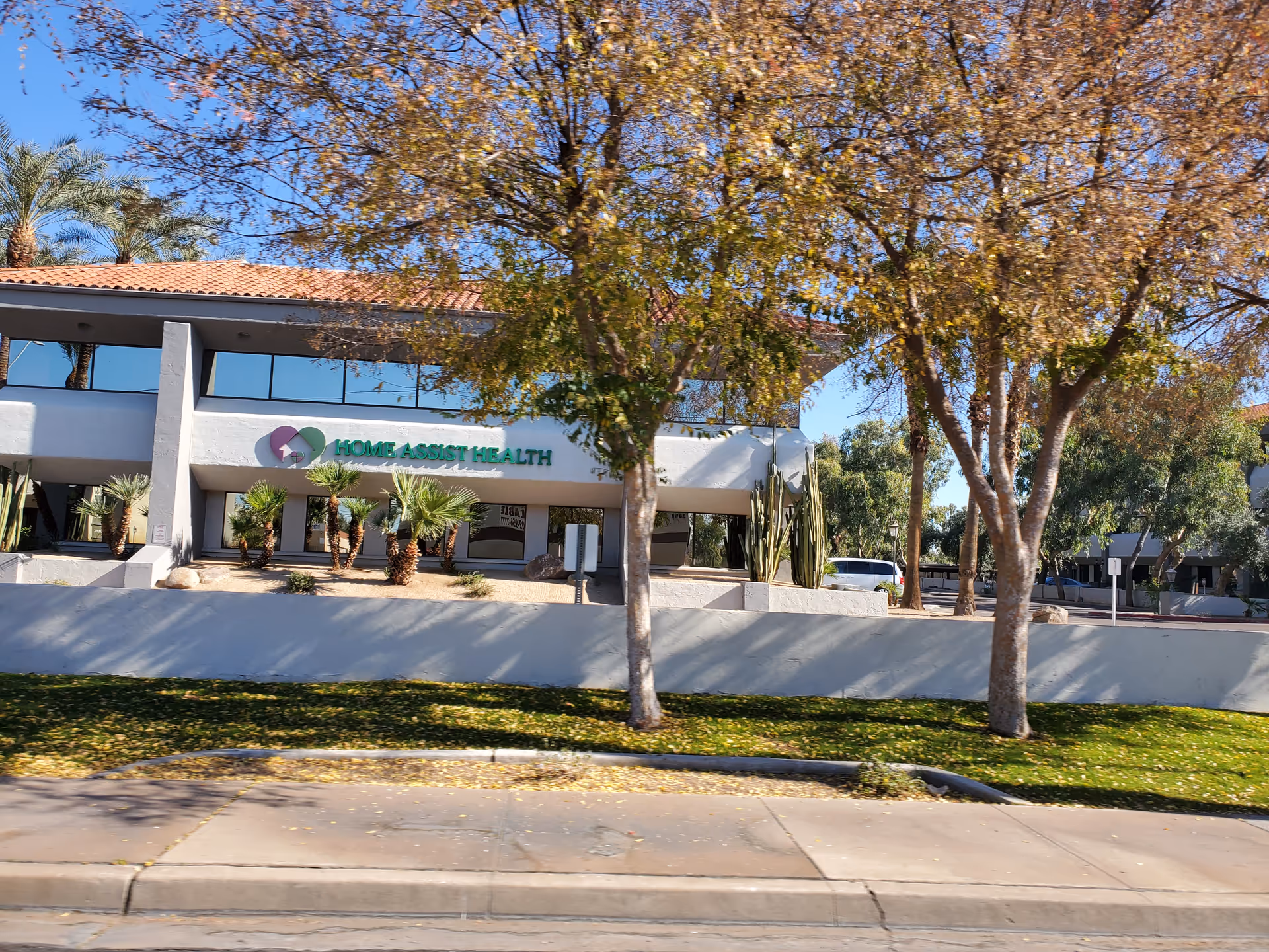 Exterior view of Home Assist Health facility with trees in front.