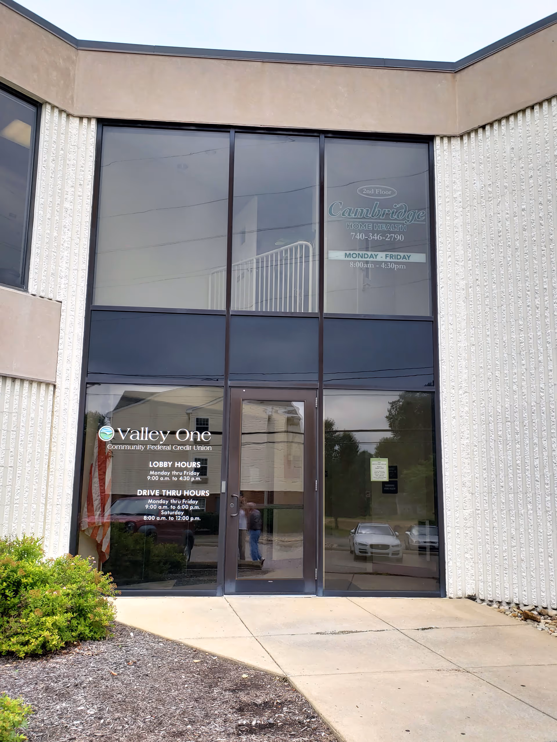 Front entrance of Cambridge Caretenders facility with large glass doors and signage.