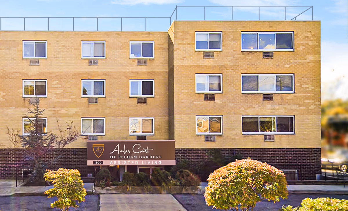 Front exterior of Amber Court of Pelham Gardens Assisted Living with signage.
