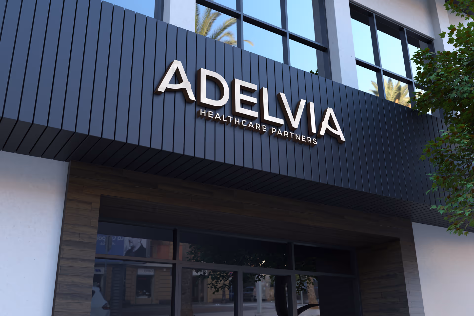 Modern Adelvia Healthcare Partners building exterior with large signage and dark facade.