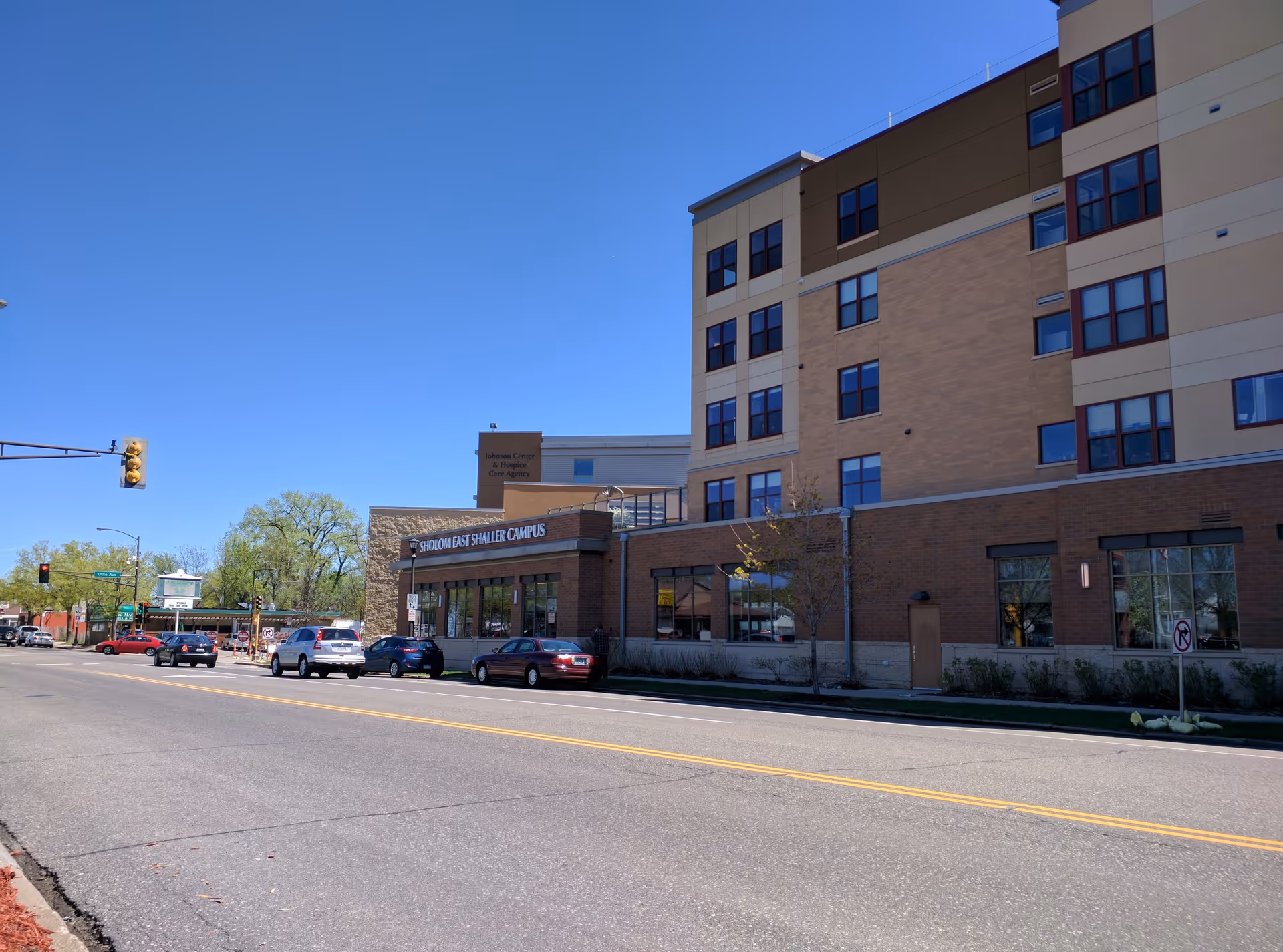 Exterior view of Shirley Chapman Sholom Home East building along a busy street.