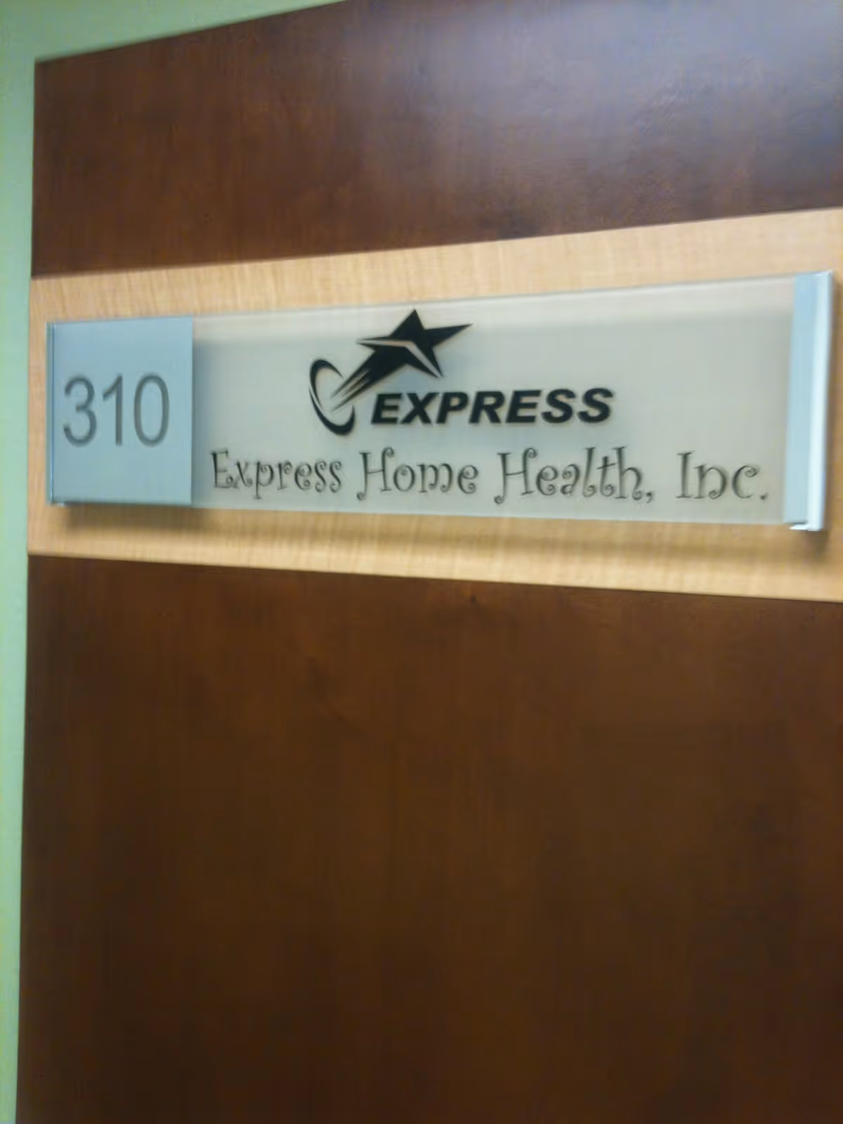 Indoor wall sign reading Express Home Health, Inc. with room 310.