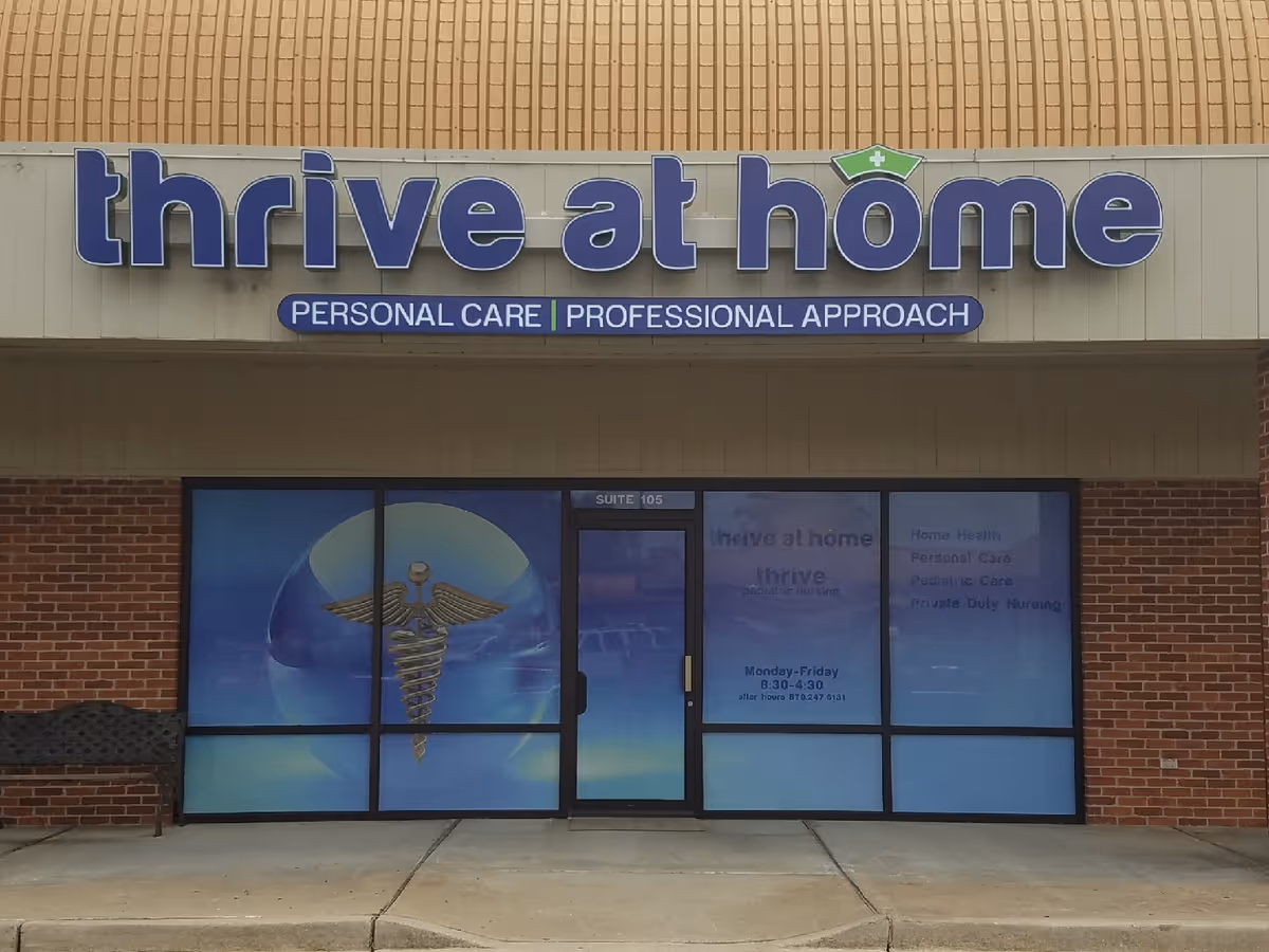 Front of Thrive at Home storefront with large blue sign and medical-themed windows.