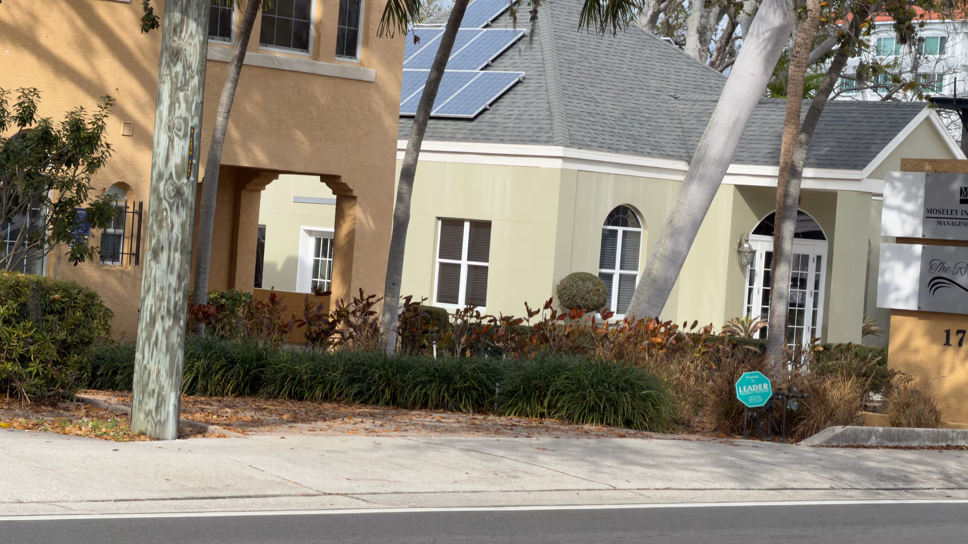 Exterior view of Magnolia on the Avenue with landscaping and signage.