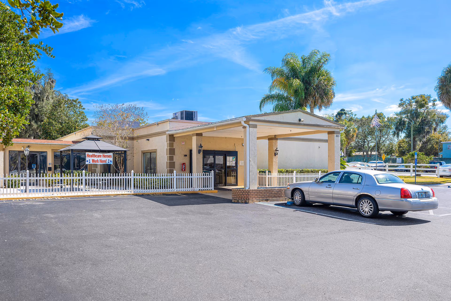 Exterior view of Bayview Center with entrance canopy, parking, and white fence.