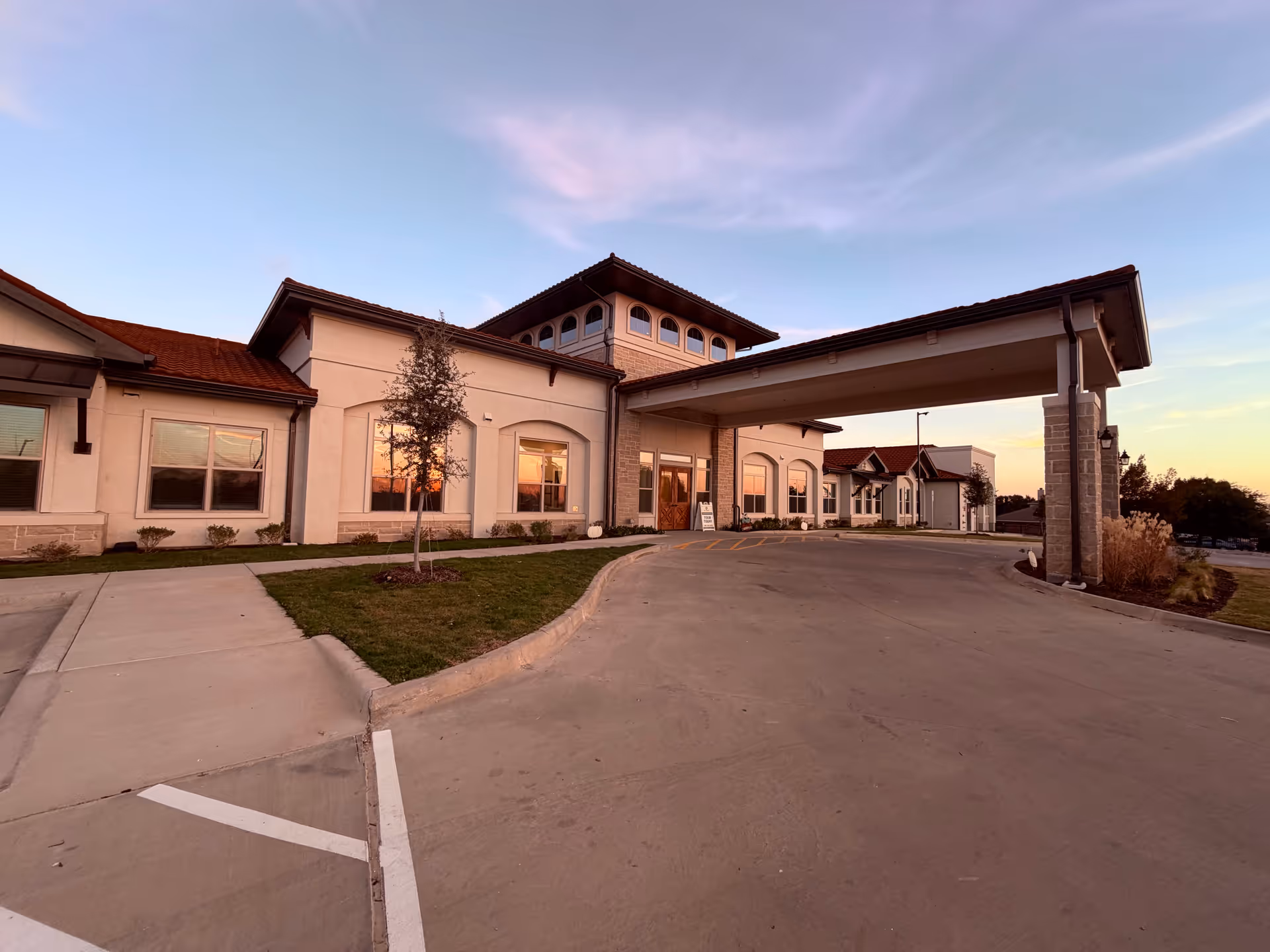 Exterior view of The Emberly at Heritage Glen entrance with a covered drop-off.