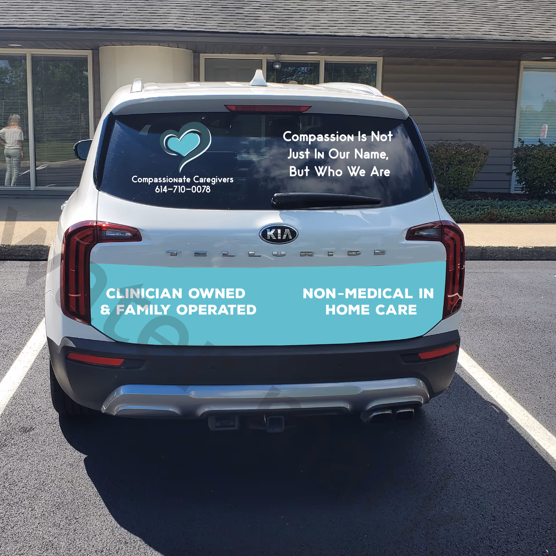 Rear view of a teal-branded Compassionate Caregivers van in a parking lot.