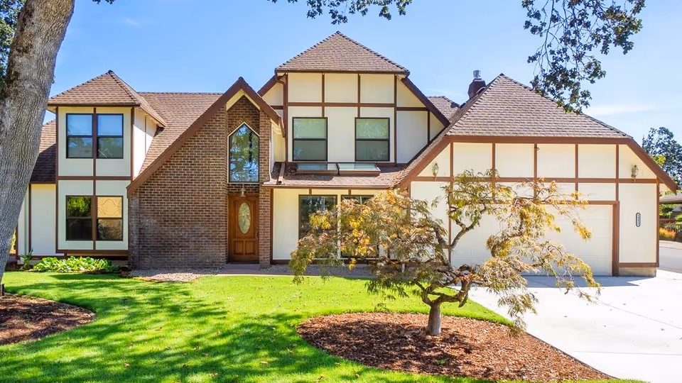 A Tudor-style senior care home with a manicured lawn and concrete driveway.