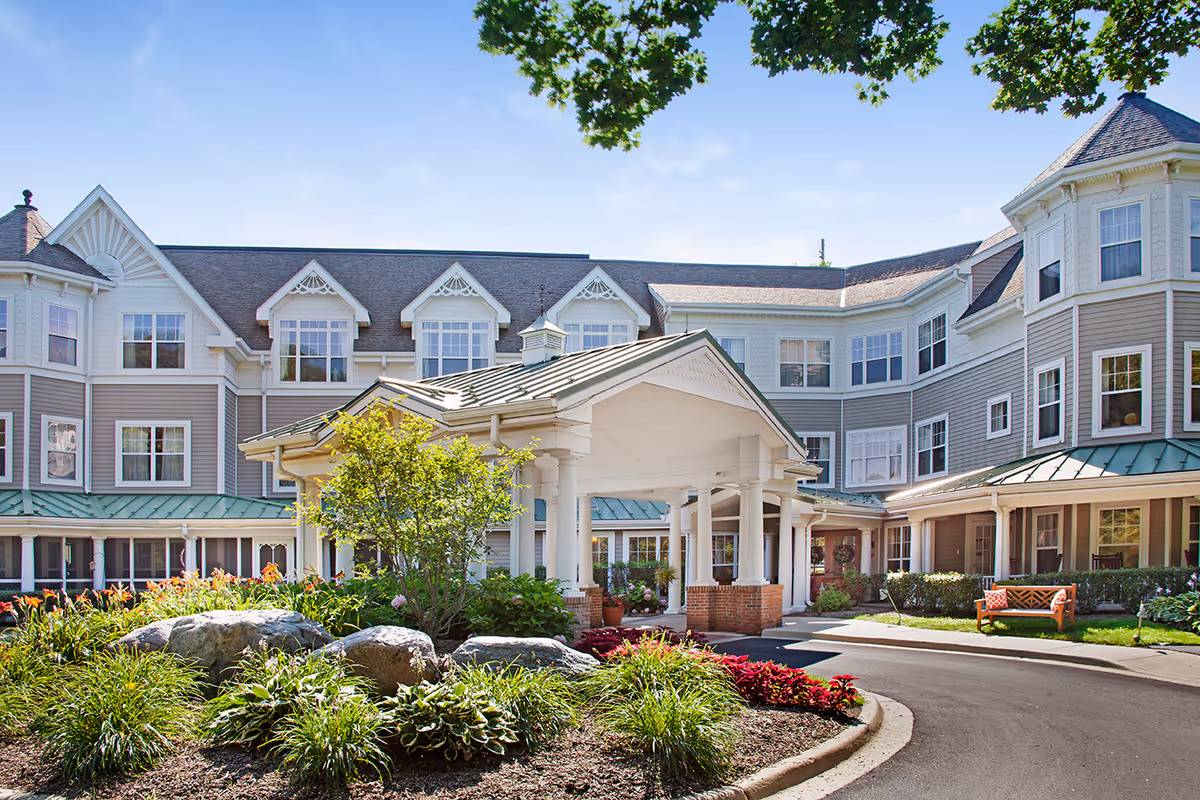 Exterior view of Sunrise of Naperville showing the entrance and landscaped grounds.
