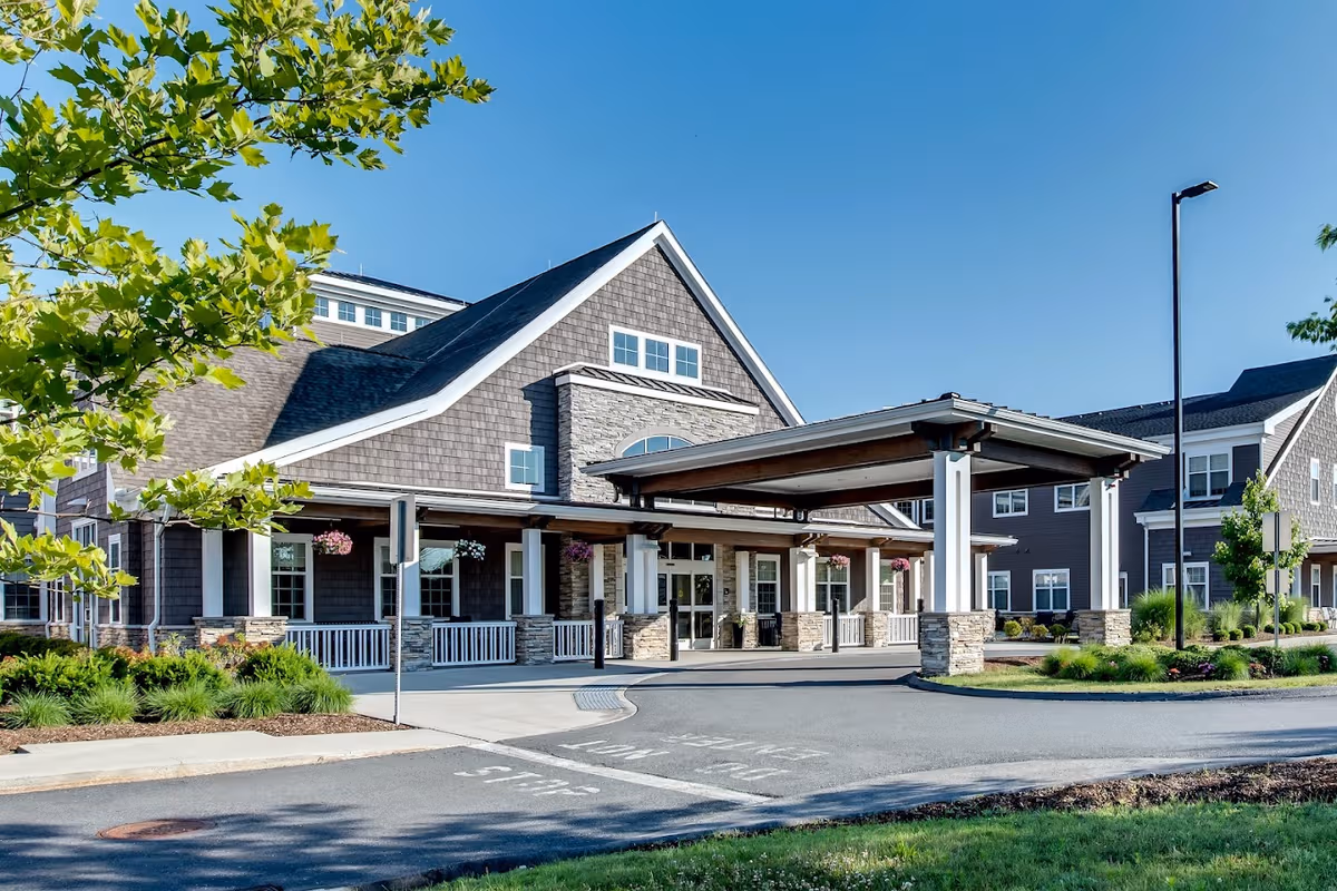 Exterior view of a modern assisted living facility with a covered entrance.