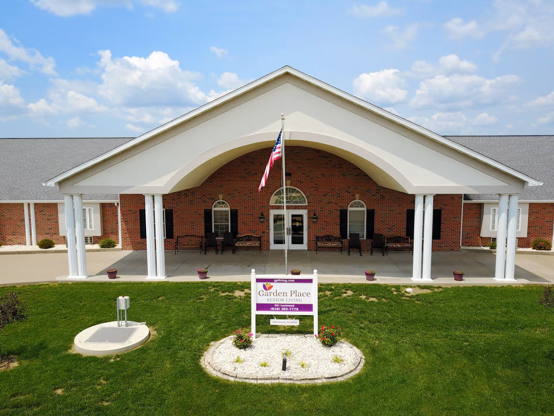 Garden Place Senior Living, Red Bud, entrance with white columns and flag