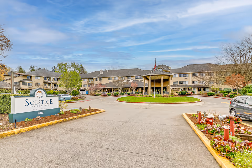 Exterior view of Solstice Senior Living at Bellingham, showing the building front and circular driveway.