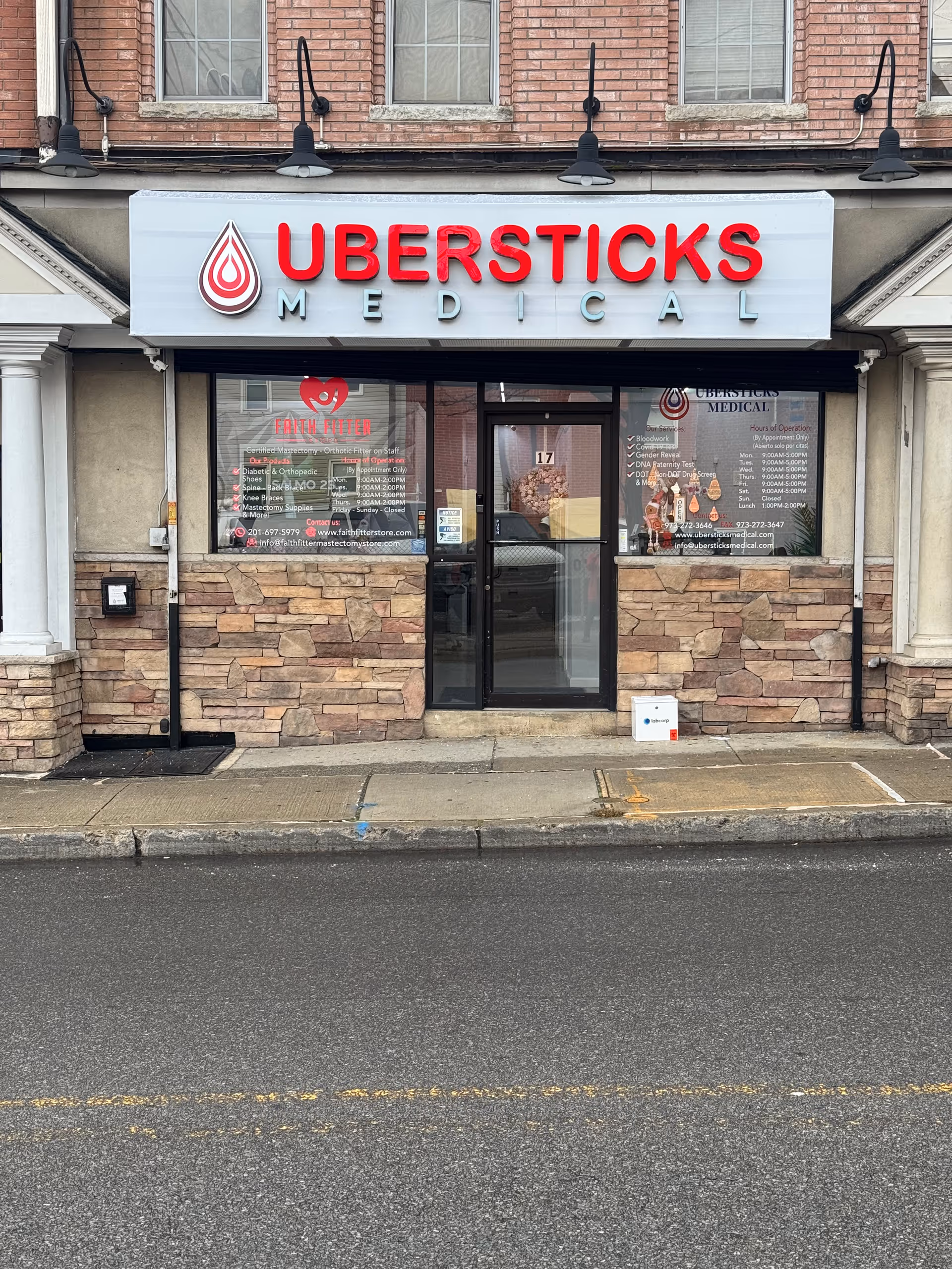 Storefront with Ubersticks Medical sign, glass door, brick and stone exterior.